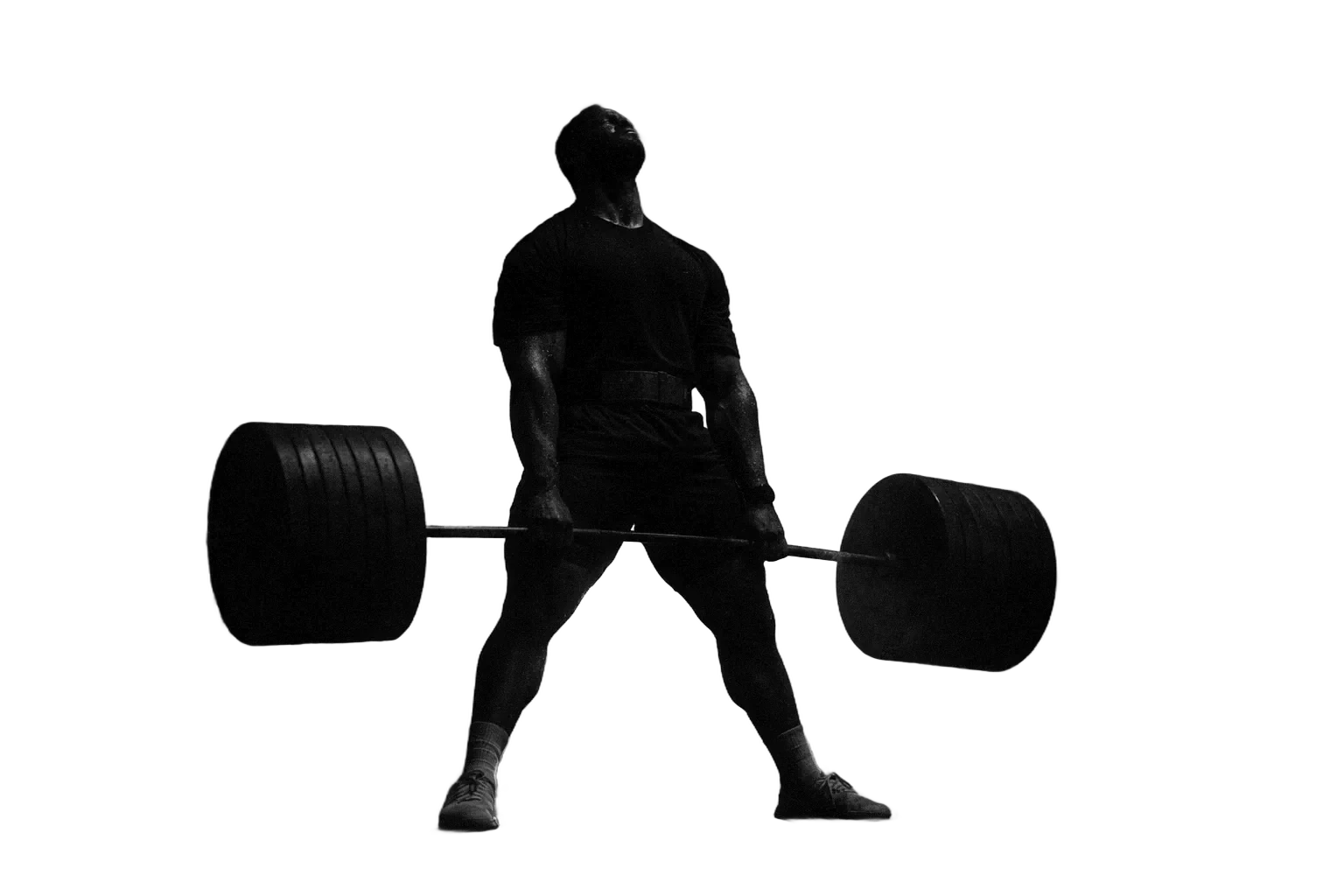 Athlète en fin de deadlift lourd, dans une salle sombre